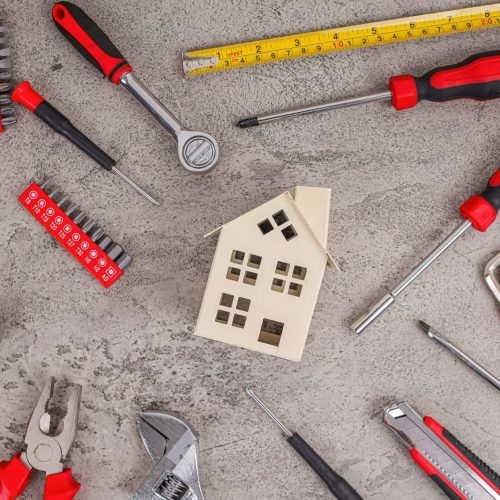 Build Your Dream Home With Essential DIY Tools Surrounding Charming House Miniature Model